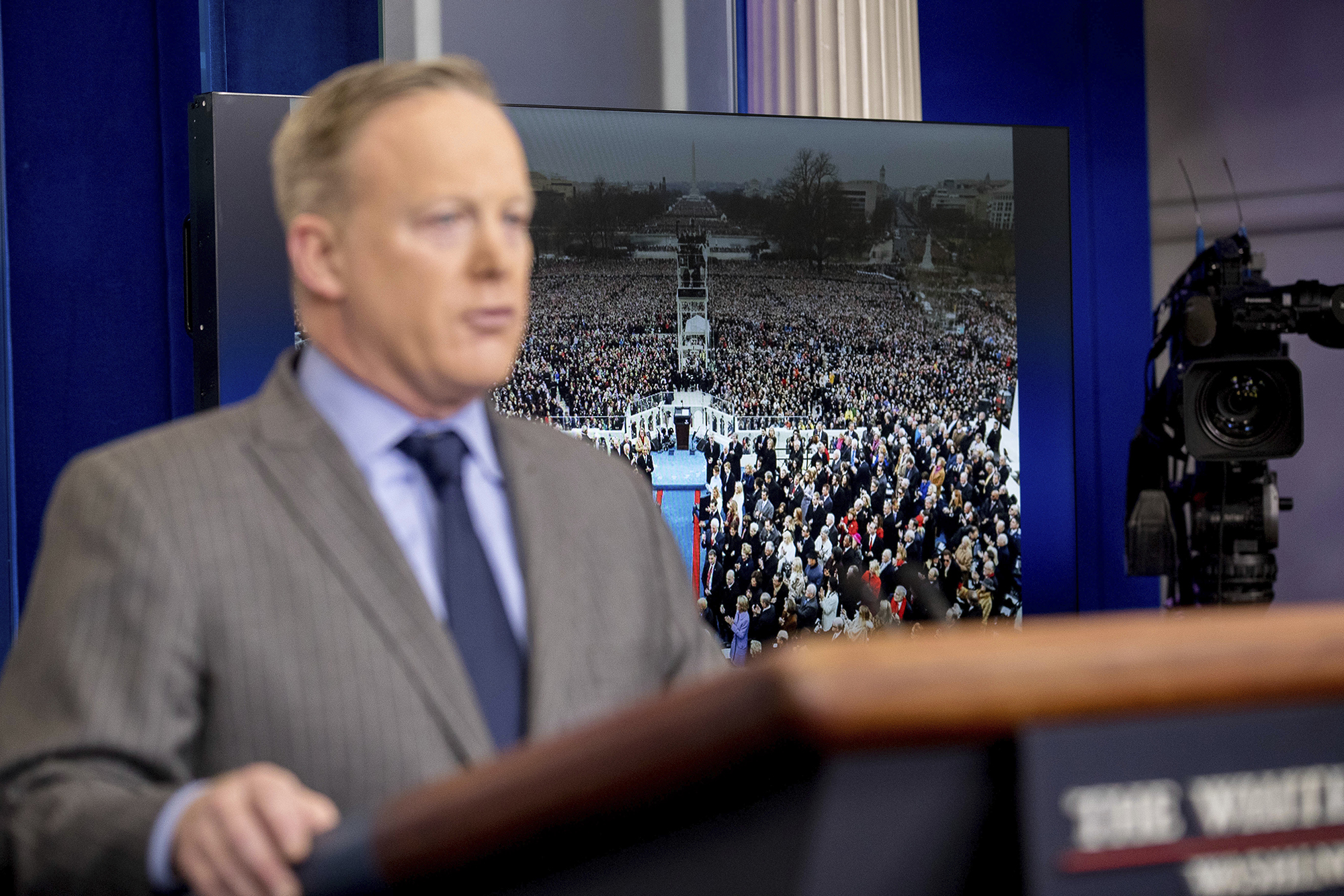 An image of the inauguration of President Donald Trump is displayed behind White House press secretary Sean Spicer as he speaks at the White House, Saturday, Jan. 21, 2017, in Washington. (AP Photo/Andrew Harnik)