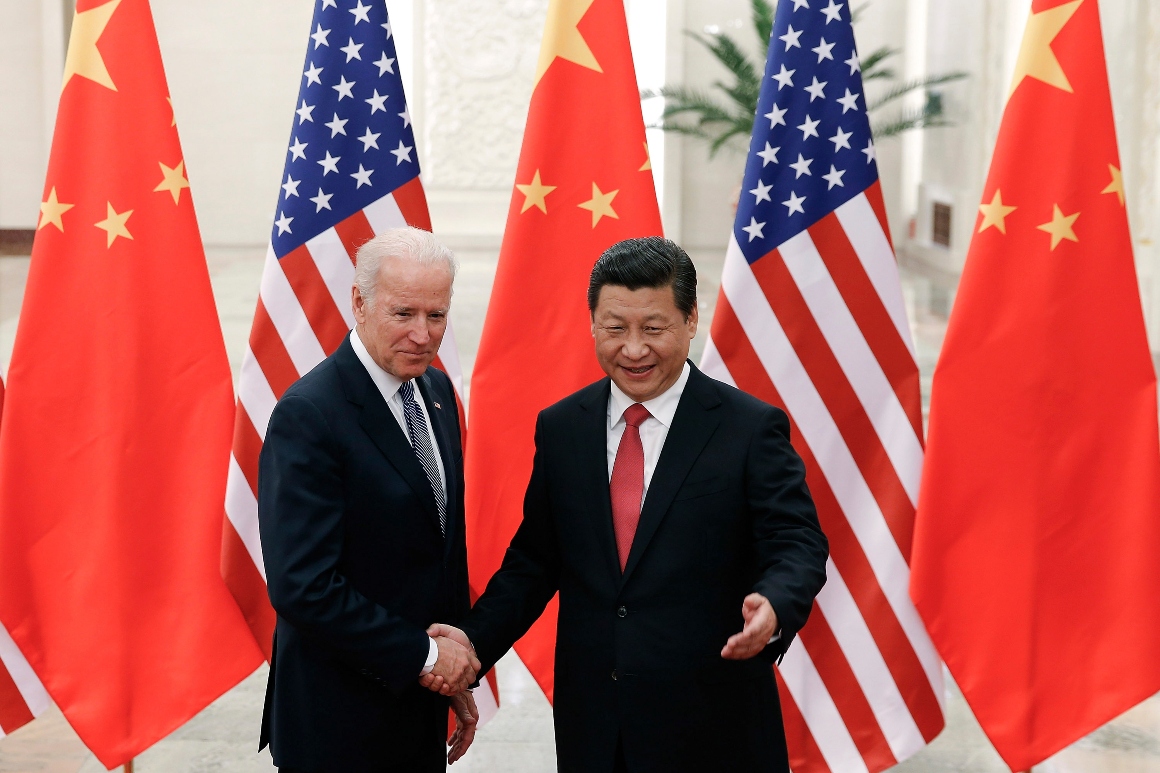 Chinese President Xi Jinping, right, shakes hands with then U.S. Vice President Joe Biden.