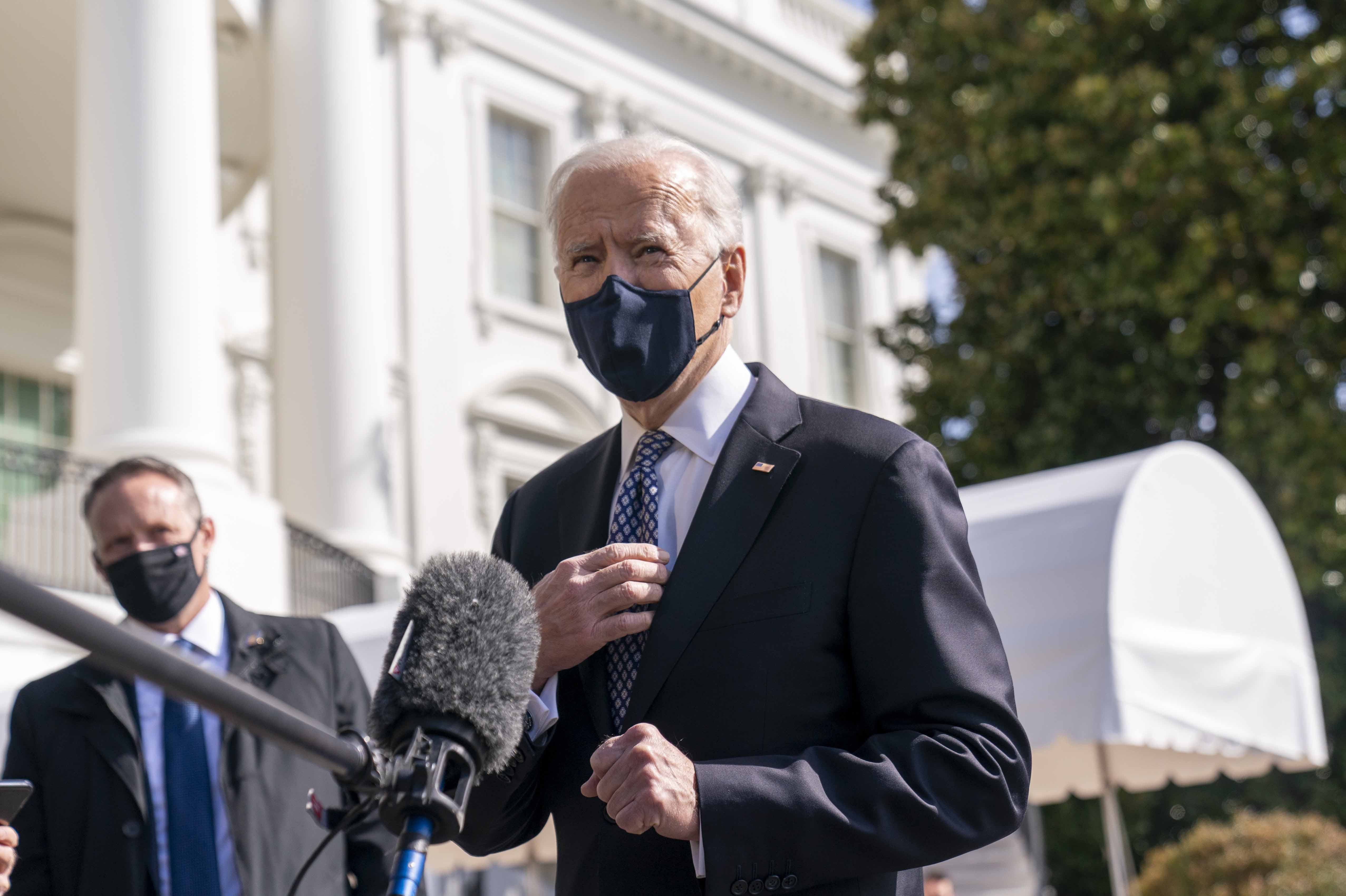 President Joe Biden speaks to reporters on the South Lawn of the White House. 