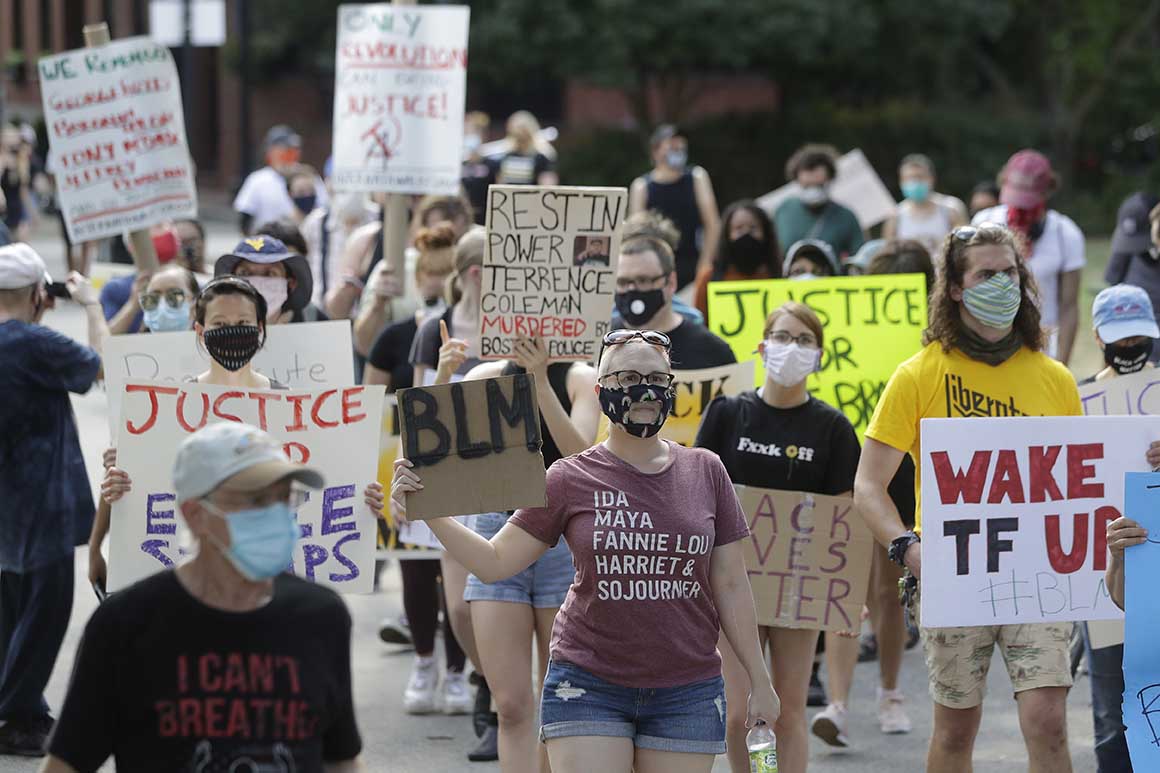 Demonstrators display placards during a protest held to call for an end to racial injustice, Sunday, Aug. 9, 2020, in Boston, triggered by the death of George Floyd.