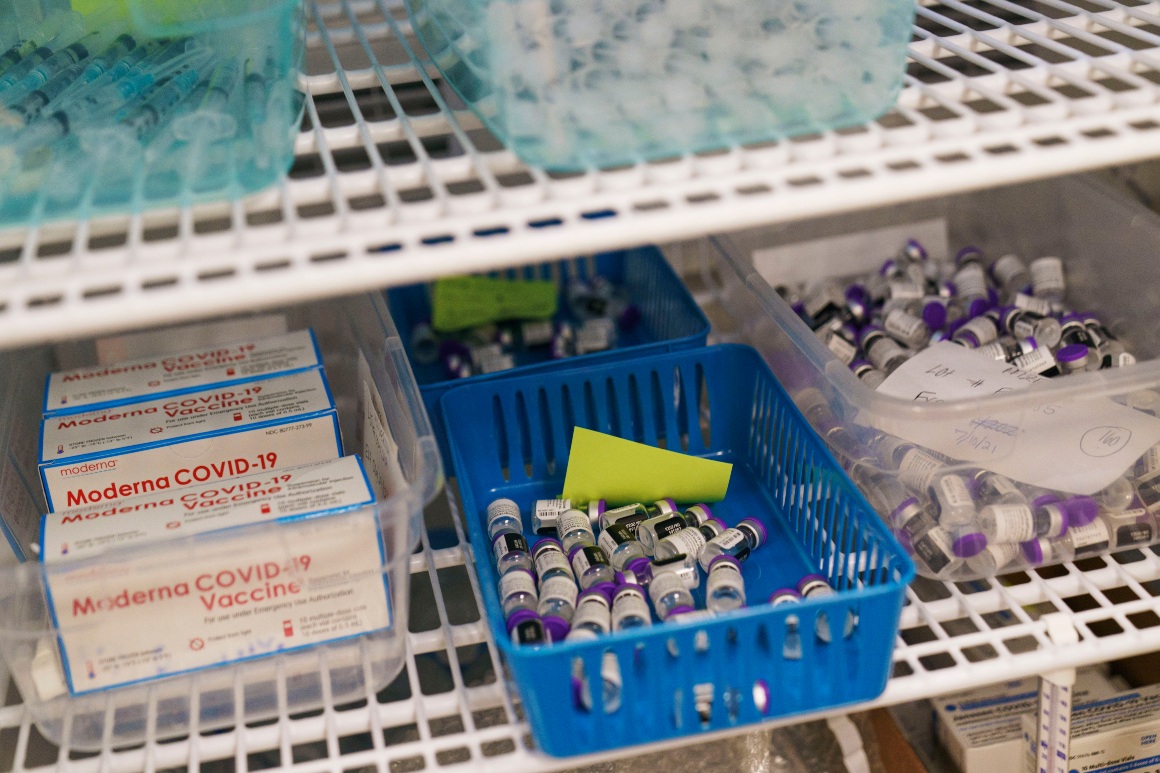 Moderna and Pfizer Covid-19 vaccines sit in a refrigerator at a mass-vaccination site.