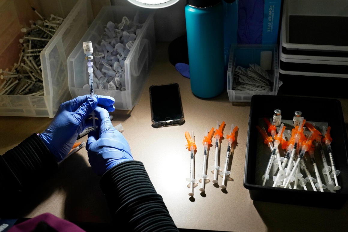 A registered nurse fills syringes with Pfizer vaccines at a Covid-19 vaccination clinic.