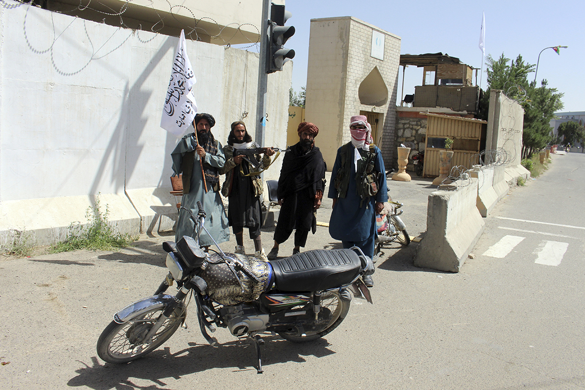 Taliban fighters stand guard inside the city of Ghazni, Afghanistan.