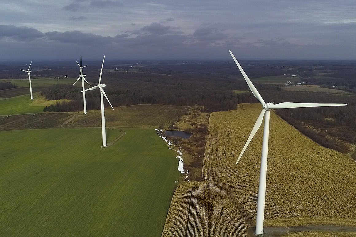 Wind turbines slowly rotate over a field in Western New York.