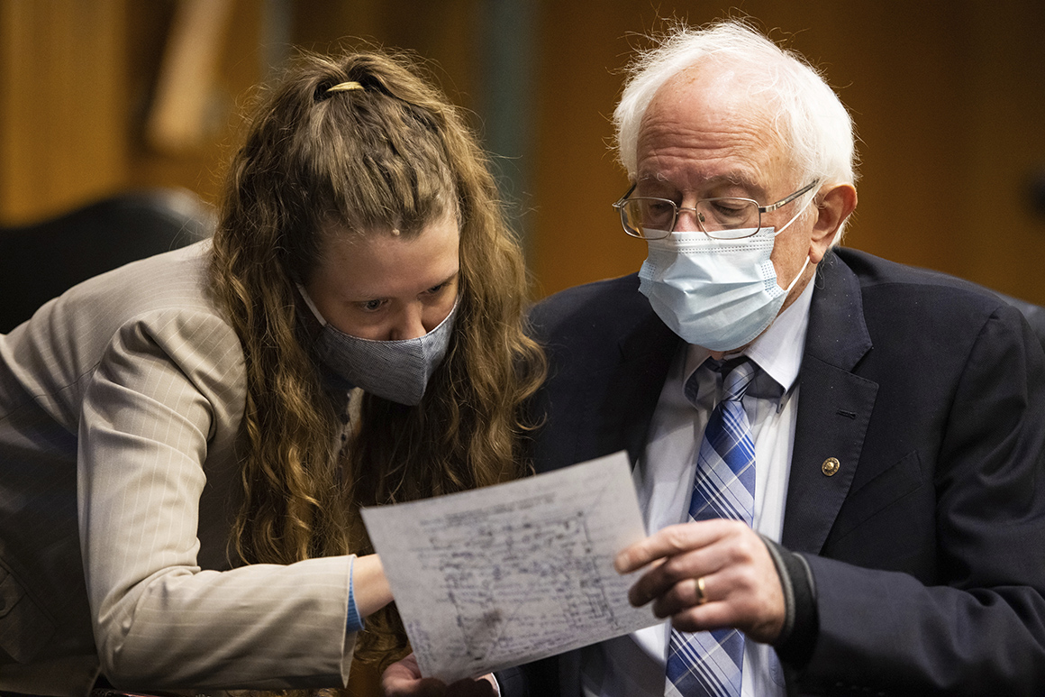 Sen. Bernie Sanders (I-Vt.) confers with a congressional staff member. 