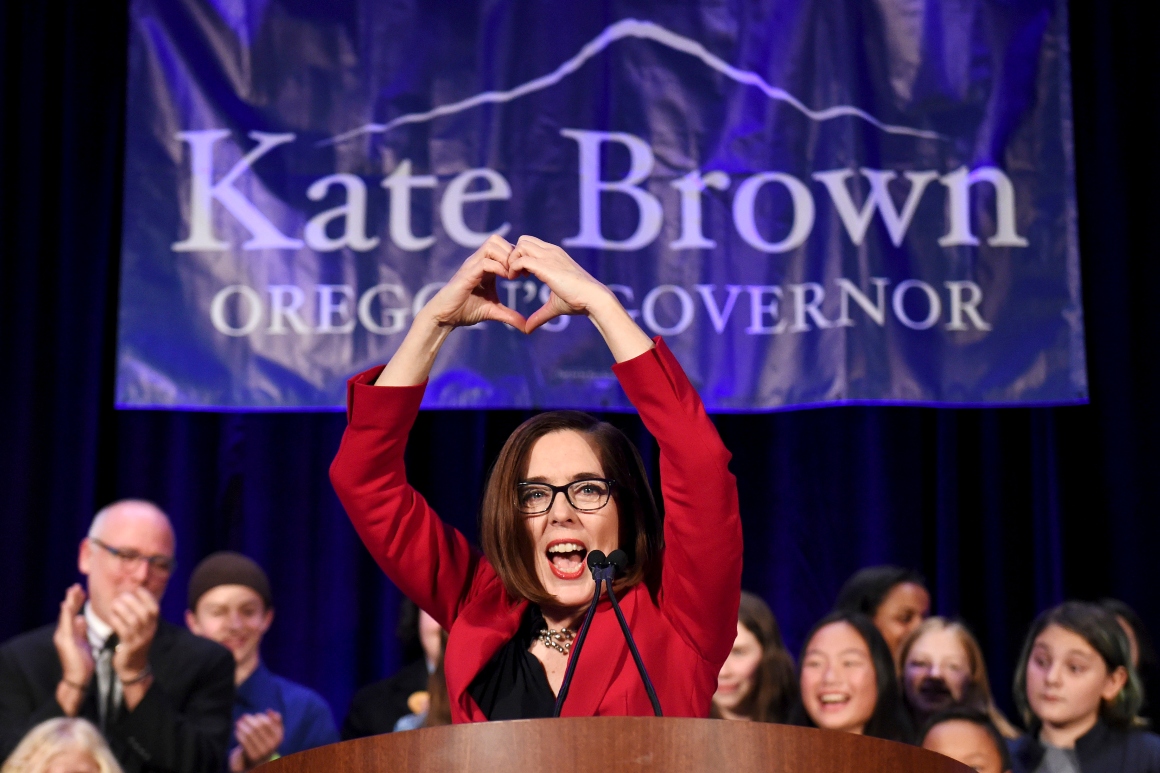 Oregon Gov. Kate Brown makes a heart shape with her hands.