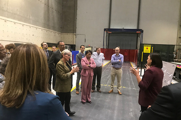 Energy Secretary Jennifer Granholm speaks while New Orleans Mayor LaToya Cantrell and other people listen on a tour of a wind power facility.