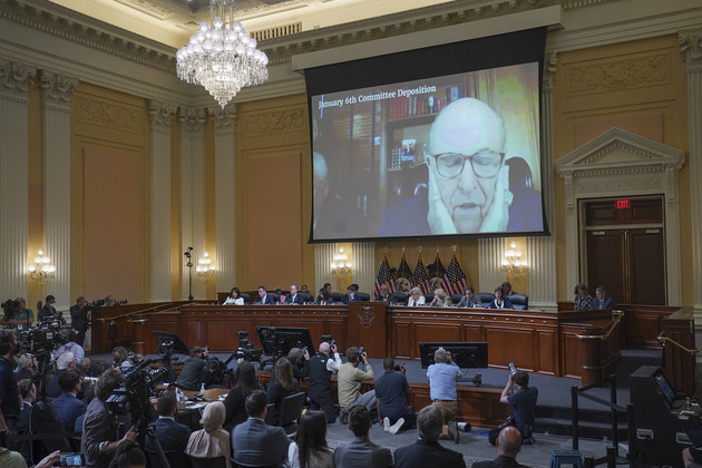 A video of Rudy Giuliani is shown on a screen at a Jan. 6 hearing.