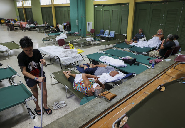 Residents affected by Hurricane Fiona rest at a storm shelter with cots in Salinas, Puerto Rico.