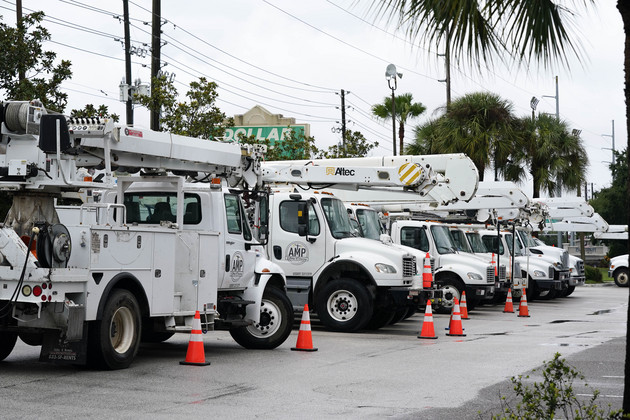Utility trucks are staged for help after Hurricane Ian moves through the state.
