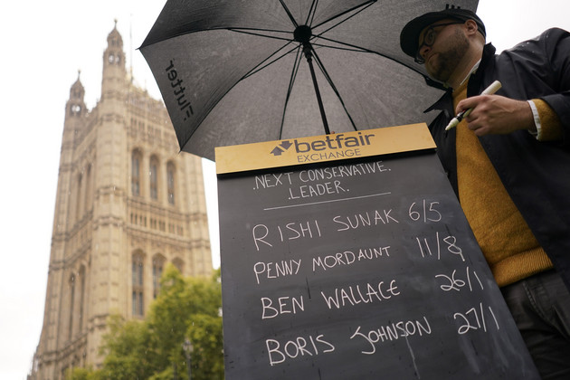A bookmaker takes bets for the next British Prime Minister after Liz Truss resigned in London.