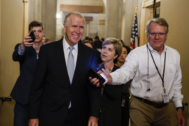 Sen. Thom Tillis (R-N.C.) speaks with reporters as he leaves a meeting with the Senate Republicans.