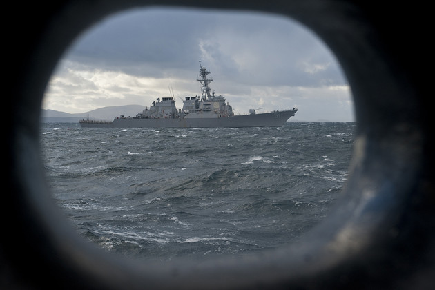 The USS Arleigh Burke is pictured through a hole in another ship.