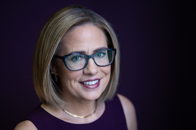 Sen. Kyrsten Sinema poses for a portrait in her office on Capitol Hill.
