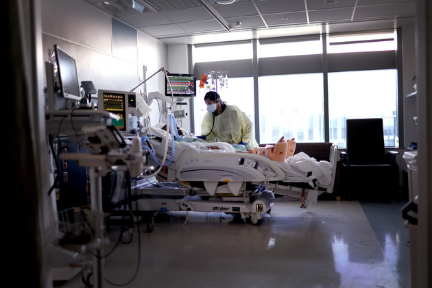 Respiratory Therapist Nirali Patel works with a COVID-19 patient in the ICU. 