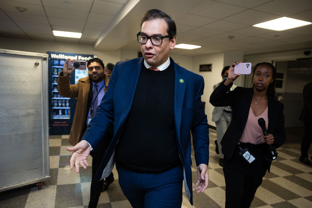 Rep. George Santos (R-N.Y.) is chased by members of the press as he walks from the Longworth House Office Building.