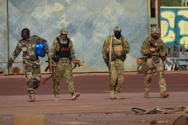 Three Russian mercenaries walk in northern Mali.