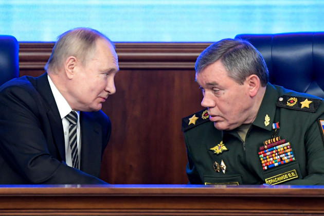 Vladimir Put, left, and Valery Gerasimov talk during a meeting. 