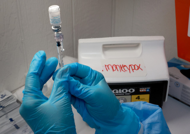 A registered nurse measures out a monkeypox vaccine shot. 