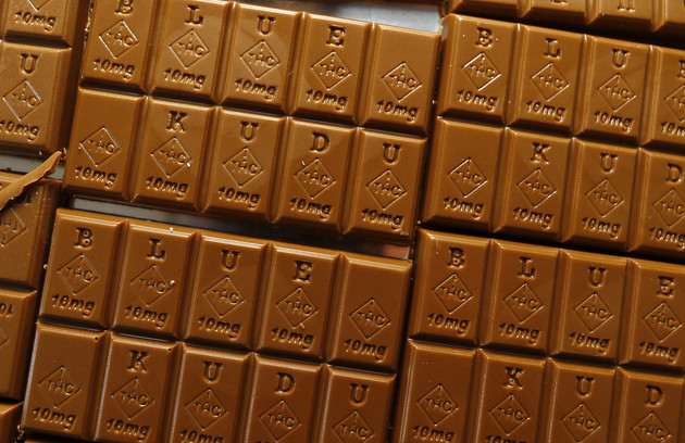 Candy bars marked with Colorado's new required diamond-shaped stamp noting that the product contains marijuana are shown.