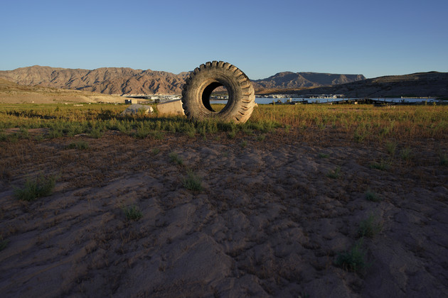 A truck tire once in the water as part of a marina sits on dry ground as water levels have dropped in Lake Mead.