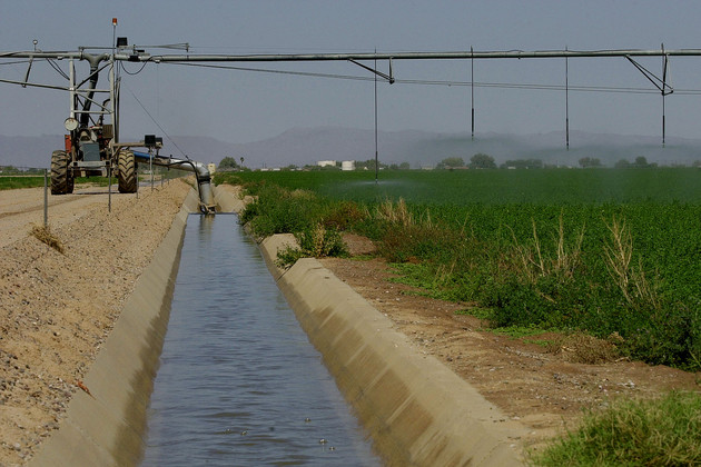 Irrigation equipment draws water from a canal to water a cotton field on the Gila River Indian Reservation near Casa Blanca, Arizona.