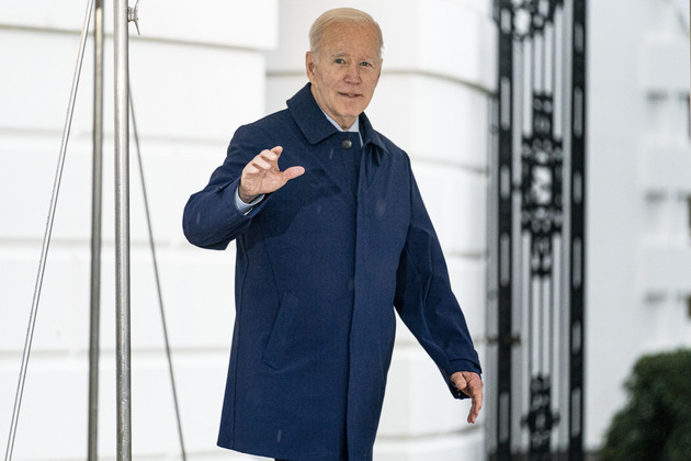 President Joe Biden waves as he walks to board Marine One. 
