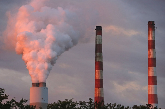 Emissions spew out of a large stack. | Getty Images