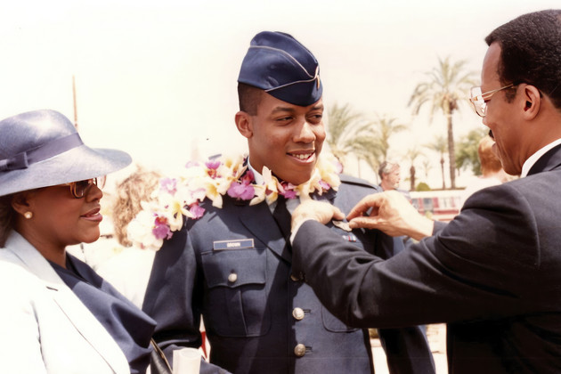 Retired Army Col. Charles Q. Brown, Sr., father, and his wife Kay Brown, pin Air Force wings onto the uniform of their son, 2nd Lt. CQ Brown, Jr.