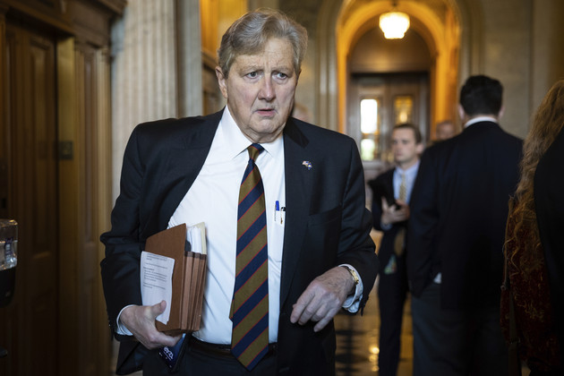 Sen. John Kennedy walks down the hall of the U.S. Capitol with a file in his hand after a vote.