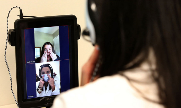 Dr. Lisa Ravindra conducts a telehealth visit with patient Jenny Thomas.
