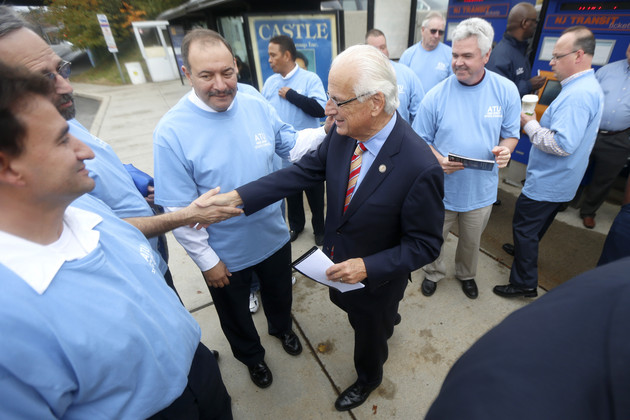Bill Pascrell stands among a group of union members and shakes hands.